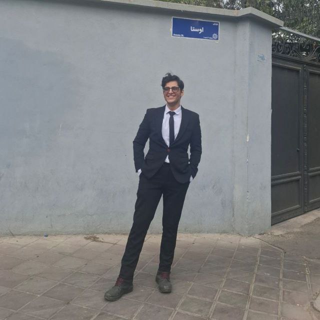 Oss Ahmad standing in a suit