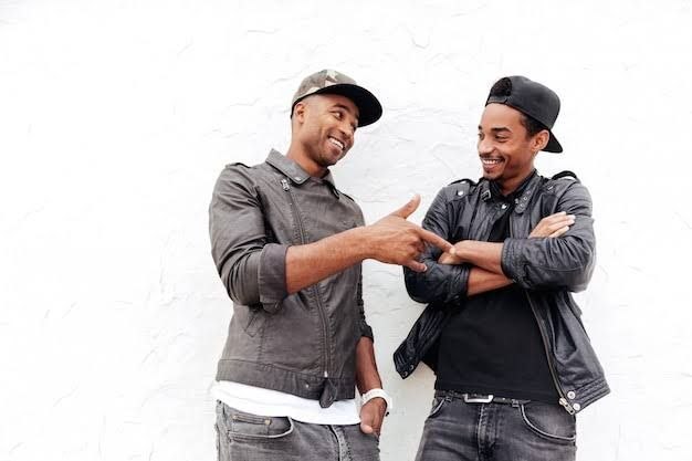 two black men speaking in a freidnly fashion